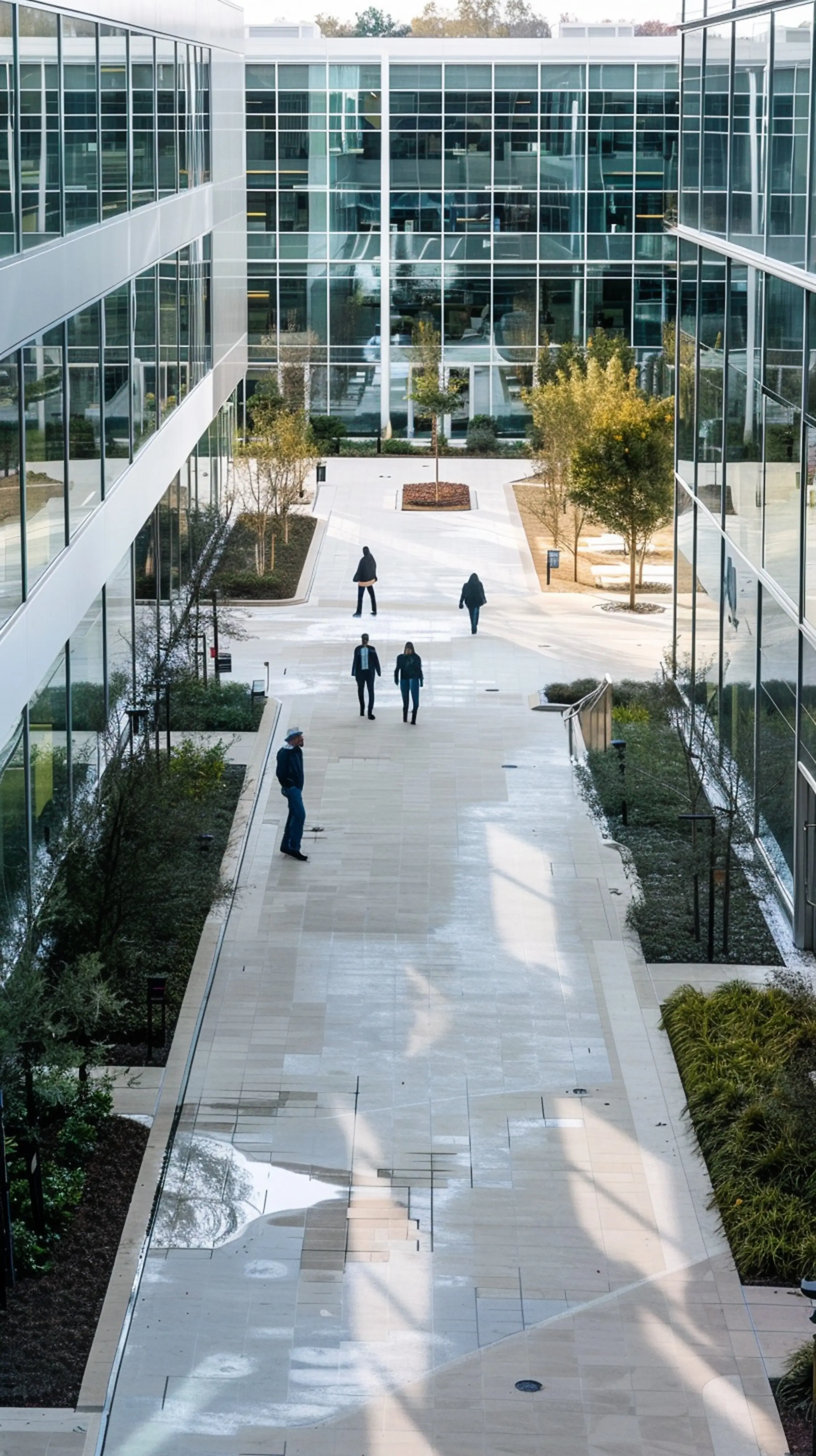 Photo of a newly built, renovated, and expanded corporate facility, captured from a bird's-eye, top-down outdoor exterior viewpoint, in a modern architectural style with bright daytime lighting, using wide-angle lenses.